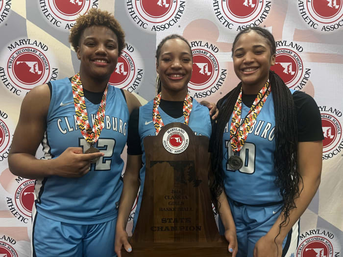 The Turner sisters (from left), London, Trinity and Destiny, are all smiles as they show off the MPSSAA Class 4A state championship trophy during the post game press conference. They each scored in double figures, combining for 36 points, to lead the Coyotes to their first state title.